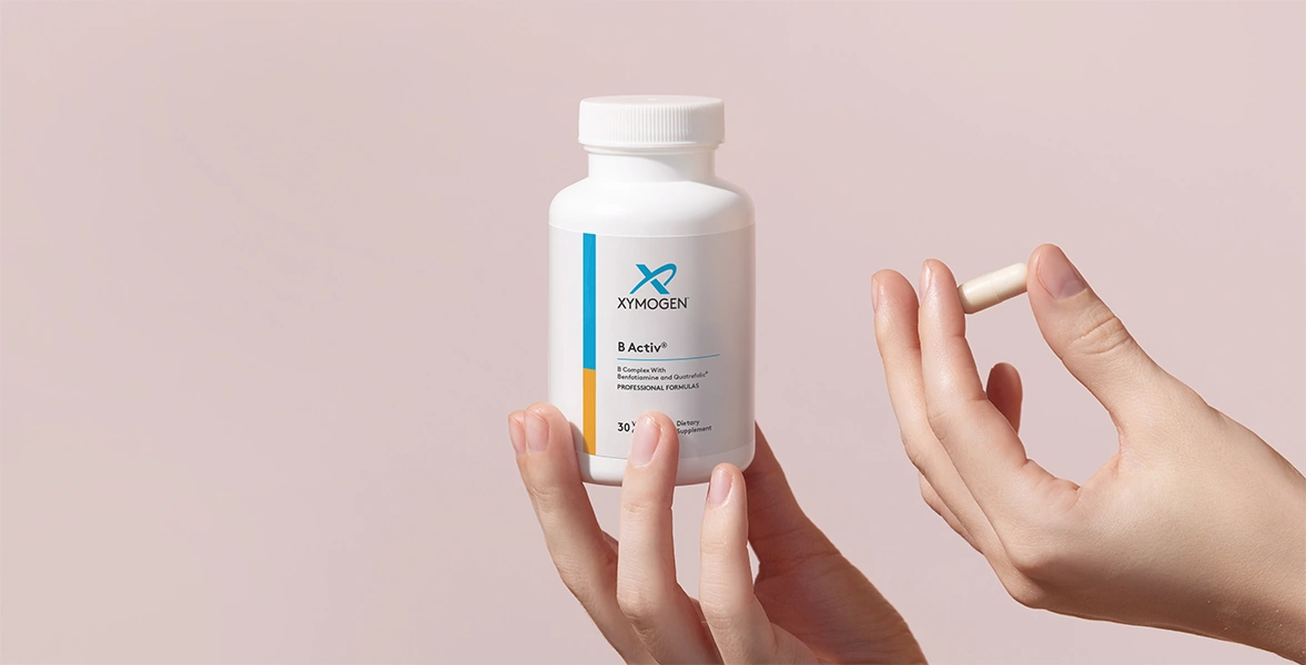 Hands
                                                 holding a bottle and a pill