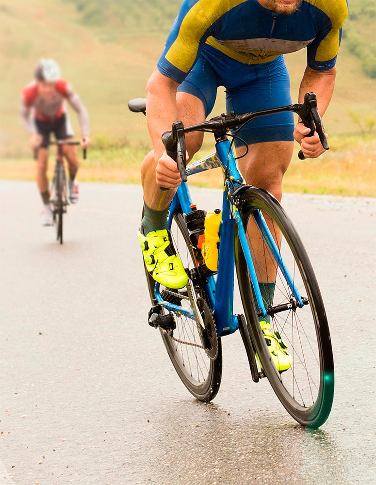 Two cyclists riding road bikes uphill